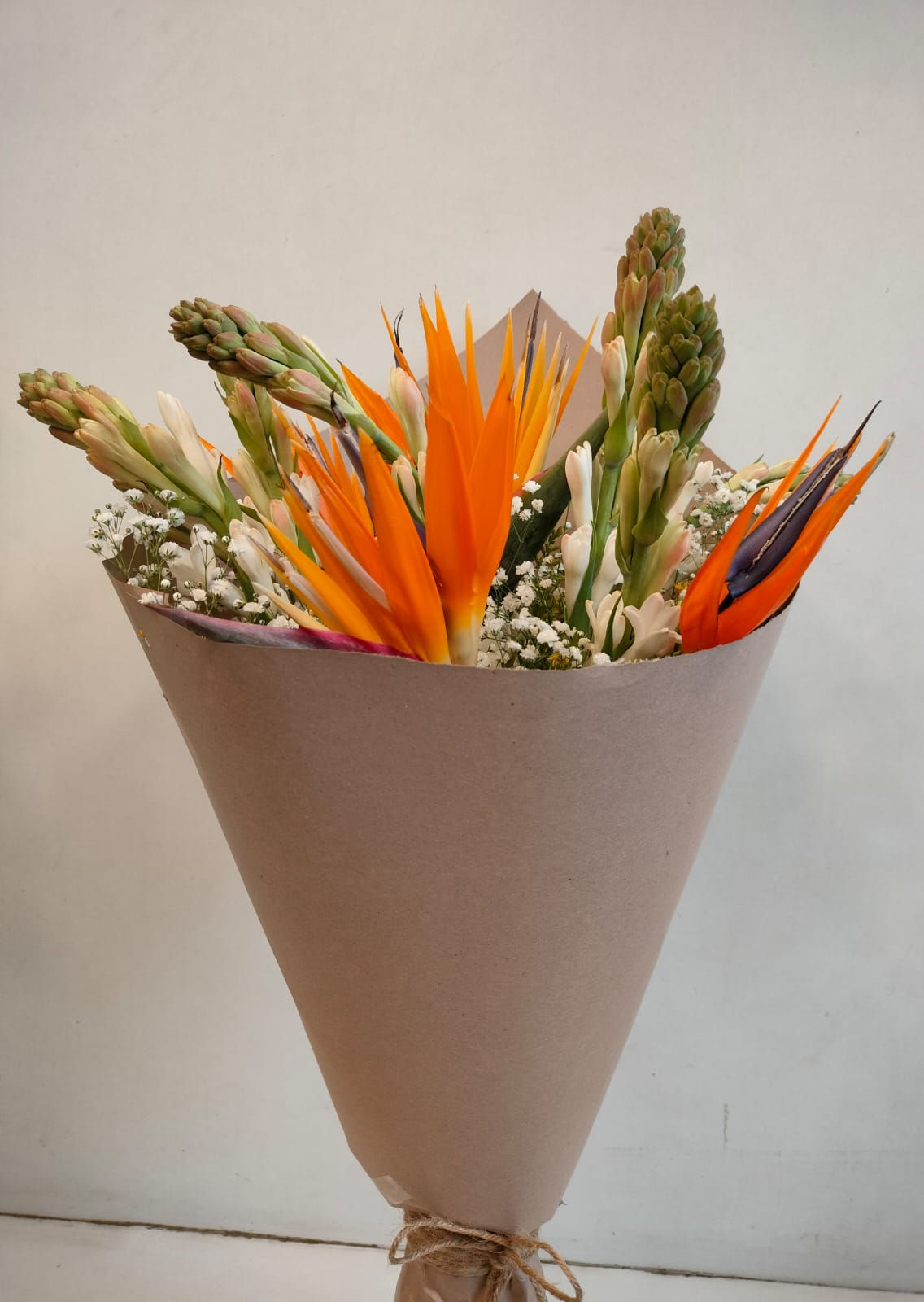 Mix of Birds of Paradise and Rajnigandha in Brown Wrap - Image 1