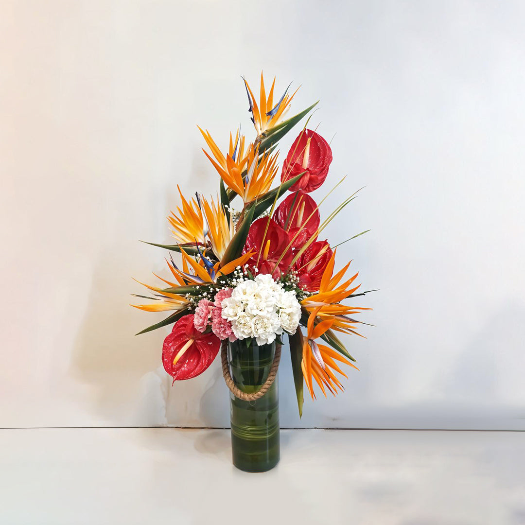Floral Arrangement of Anthuriums, Birds of Paradise and Carnations in Glass Vase