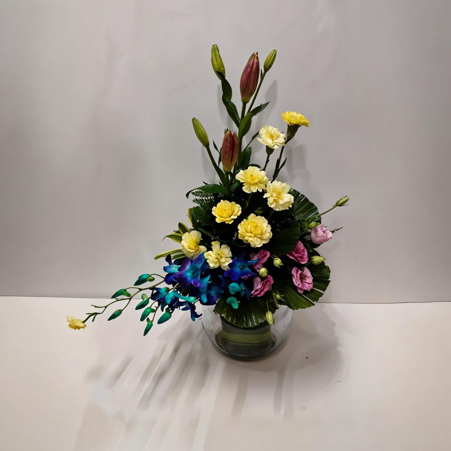 Mixed Flower Arrangement with Asiatic Lily, Carnations, Eustomas and Orchids in Fish Bowl