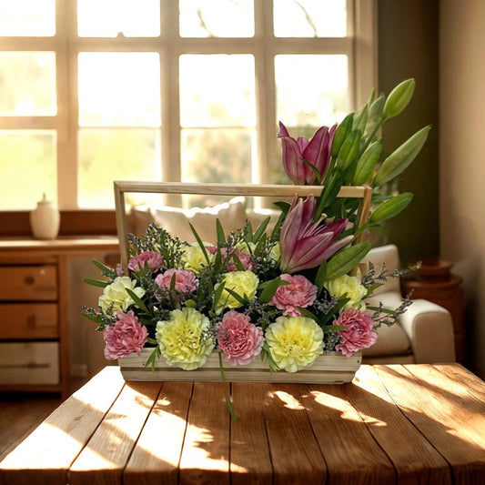 Flower arrangement with Asiatic Lily and Carnations in Wooden Basket