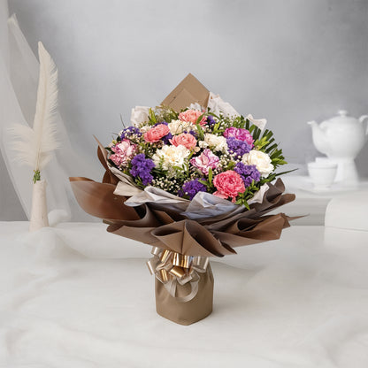 Bouquet of Carnations and Blue Daisies in Premium Wrap